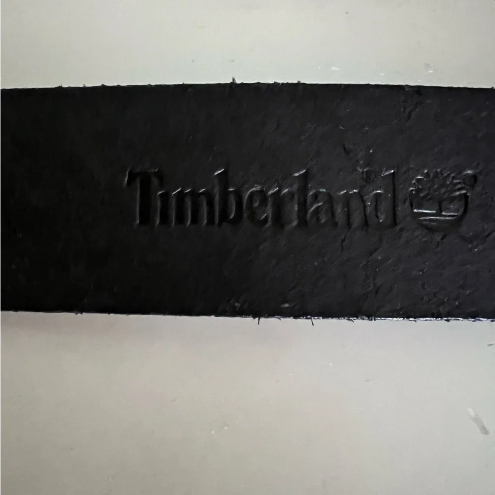 Timberland black leather belt laser etched floral design. Silver art deco buckle